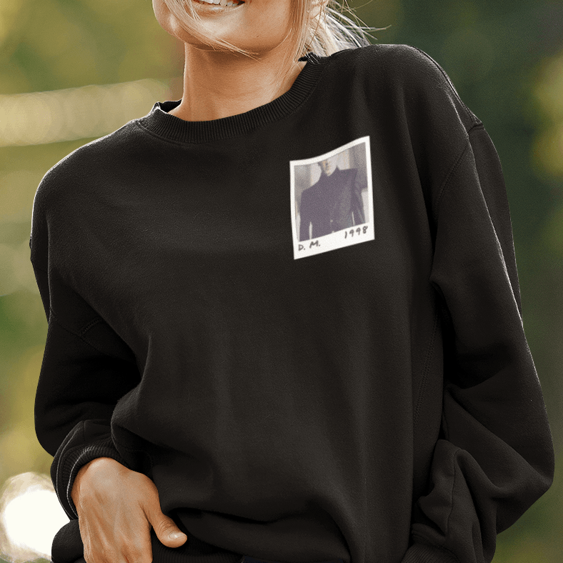 Model wearing black sweatshirt with a design of a polaroid of Draco Malfoy on the left chest. 
